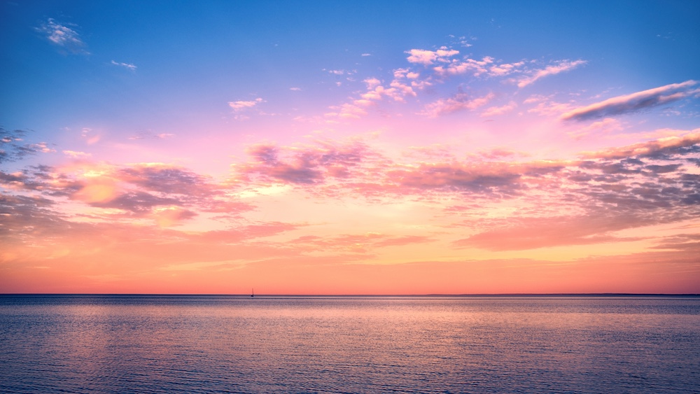 Beautiful sunset over Lake Superior with a sail boat